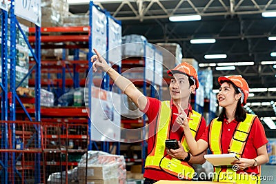 Supervisor and manager smiling happy hold scanner on hand visit warehouse as annual audit inventory stock check in large warehouse Stock Photo