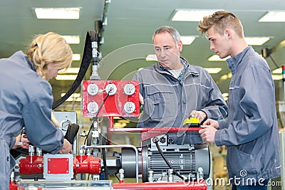 Supervisor training new recruits in factory Stock Photo