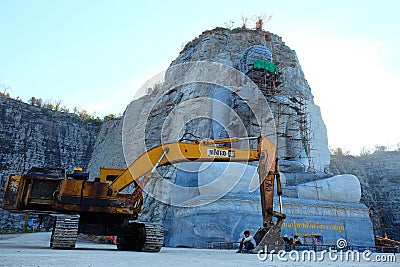 Yellow industrial excavator parked on construction site yard Editorial Stock Photo