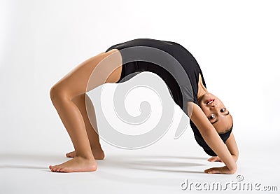 Supple girl bending backwards to form a bridge Stock Photo