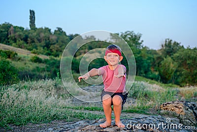 Supple young boy practicing pilates outdoors Stock Photo