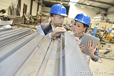 Supplier with engineer checking on production in metallurgic factory Stock Photo