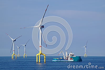Supply boat with offshore wind turbine Stock Photo