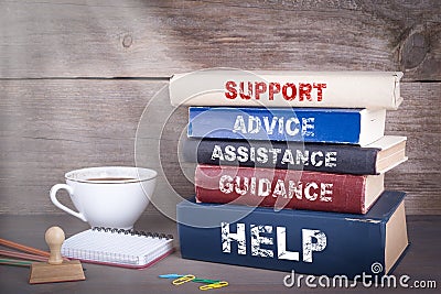 Support concept. Stack of books on wooden desk Stock Photo