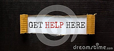 Support and get help here symbol. Words `get help here` appearing behind torn black paper. Beautiful black background. Business, Stock Photo