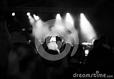 Supporters recording at concert, black and white, noise Stock Photo