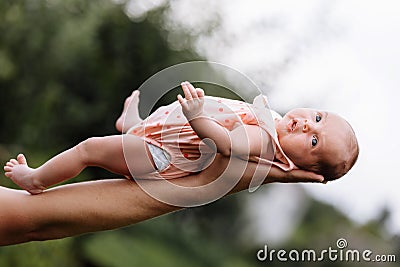 Supporting Hands. Father holding his 14 days old baby girl on his arms Stock Photo