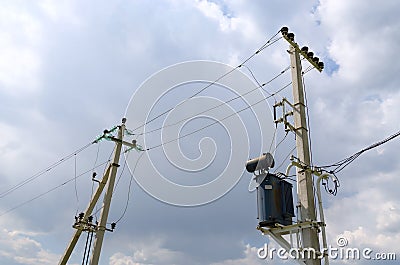 Supporting pillars of power line in rural location Stock Photo