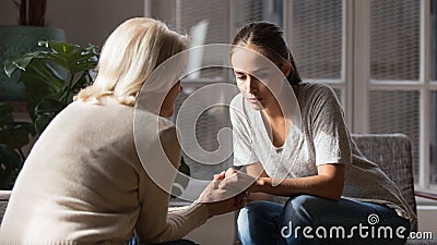 Supportive mature mother comfort unhappy grownup daughter Stock Photo