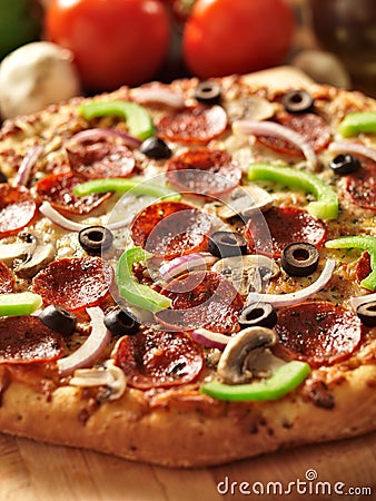 Supreme italian pizza with pepperoni and toppings Stock Photo