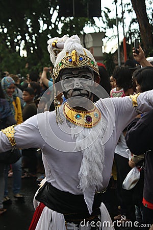 A man in painted face wearing Hanuman costume in a parade. Editorial Stock Photo