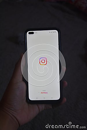 Surabaya, Indonesia. 08-28-2023: a smartphone held in the hand, with the home screen display of the Instagram application for Editorial Stock Photo