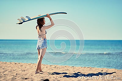 Surf girl go to surfing- Beautiful girl surfer looking for the w Stock Photo