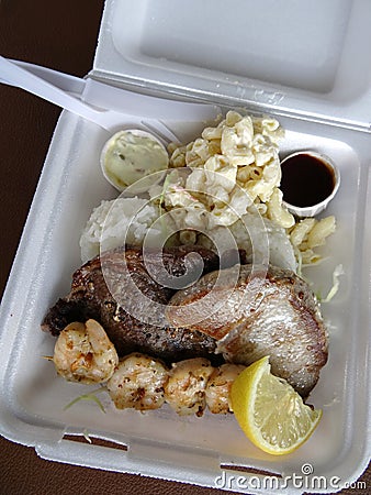 Surf & Turf Includes: Ahi, Steak, Shrimp, rice, and mac salad Stock Photo