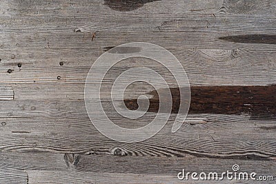 Surface of a heavily weathered wooden bench in the park, with larger water spots Stock Photo