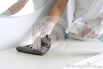 Surface home cleaning spraying antibacterial sanitizing spray bottle disinfecting against COVID-19. Closeup Stock Photo