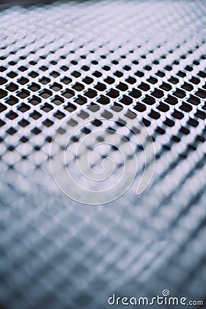 Surface of latticed metal fence. Stainless steel and aluminum light blur background. Macro texture Stock Photo