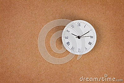 Surface of roman number clock on brown paper background Stock Photo