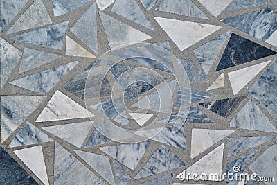 The surface of the wall or floor is made of triangular pieces of marble or granite Stock Photo