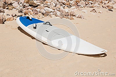 Surfboard lies on the sand on the beach Stock Photo