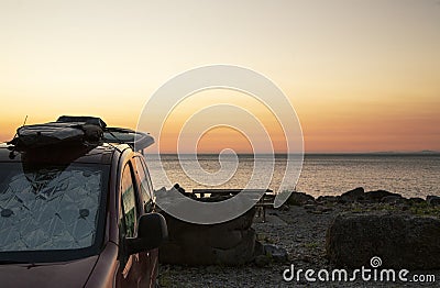 Surfboard on the roof of a van, let the road trip begin. Image with copy space Stock Photo