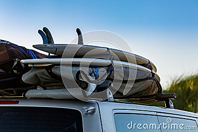 Surfboards fixed on a top of a car. Surftrip. Stock Photo