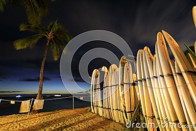 Surfboards stack on the landmark Waikiki Beach at sunset Stock Photo