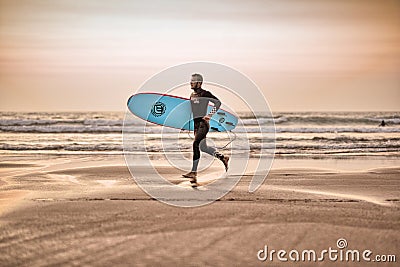 Surfer on Amado Beach Editorial Stock Photo