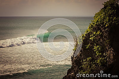 Surfer on a barrel wave getting tubed on his surfboard Stock Photo