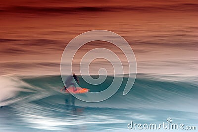 Surfer catching the wave Stock Photo