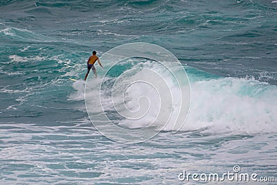 Surfer catching a wave at Ho`okipa Hawaii Editorial Stock Photo