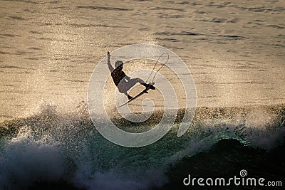 Surfer doing air reverse at Uluwatu at sunset. Extreme sports. Lifestyle. Bali, Indonesia. Editorial Stock Photo