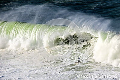 Surfer on Getxo challenge of huge waves Stock Photo