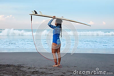 Surfer Girl. Surfing Woman With Surfboard On Head Standing On Sandy Beach. Brunette In Blue Wetsuit Going To Surf In Sea. Stock Photo