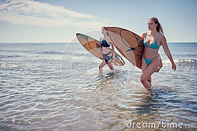 Surfer girl walking with board. Surfer girl. Beautiful young woman at the beach. water sports. Surfing. Summer Vacation. . Stock Photo