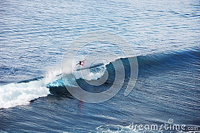 Surfer in ocean. Bali surfing aerial shot Stock Photo