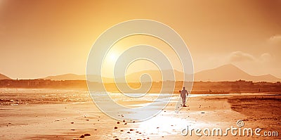 Surfer on the ocean beach at sunset on Canary Islands Editorial Stock Photo