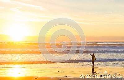 Surfer ocean beach sunset sunbeam Stock Photo