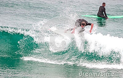 Surfer ride waves in slow motion at Las Canteras beach in Las Palmas de Gran Canaria, Spain Editorial Stock Photo