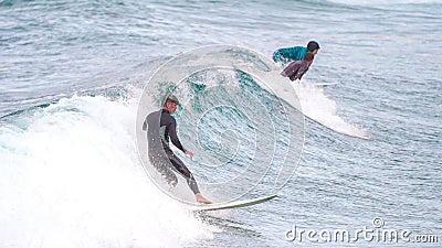 Surfer ride waves in slow motion at Las Canteras beach in Las Palmas de Gran Canaria, Spain Editorial Stock Photo