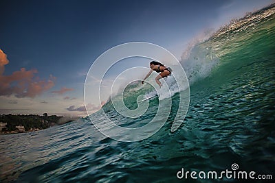 A surfer riding on green ocean wave Stock Photo