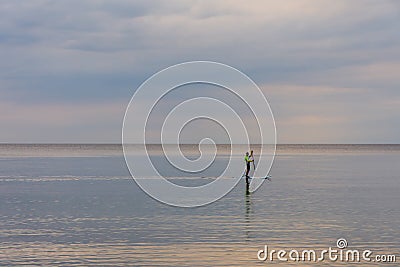 Surfer sailing on calm sea water Stock Photo