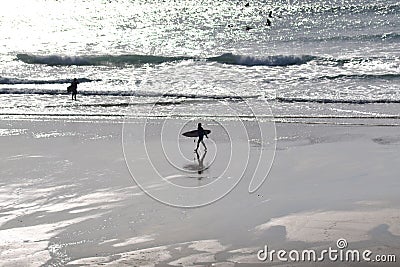Surfer scene at dusk Stock Photo