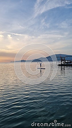 Surfer on the sea surface at sunset time Editorial Stock Photo