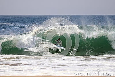 Surfer surfing a large wave at The Wedge in Newport Beach California Editorial Stock Photo