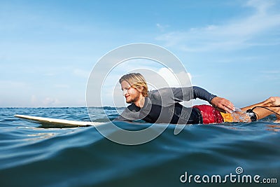 Surfer. Surfing Man On Surfboard Portrait. Handsome Guy In Wetsuit Swimming In Ocean. Stock Photo