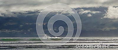 Surfer on waves in dramatic seascape Stock Photo