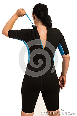 Surfer woman closing zipper to wetsuit Stock Photo