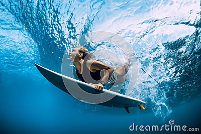 Surfer woman dive underwater. Surfgirl dive under wave Stock Photo