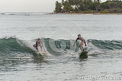 Surfers riding the waves in Sri Lanka Editorial Stock Photo